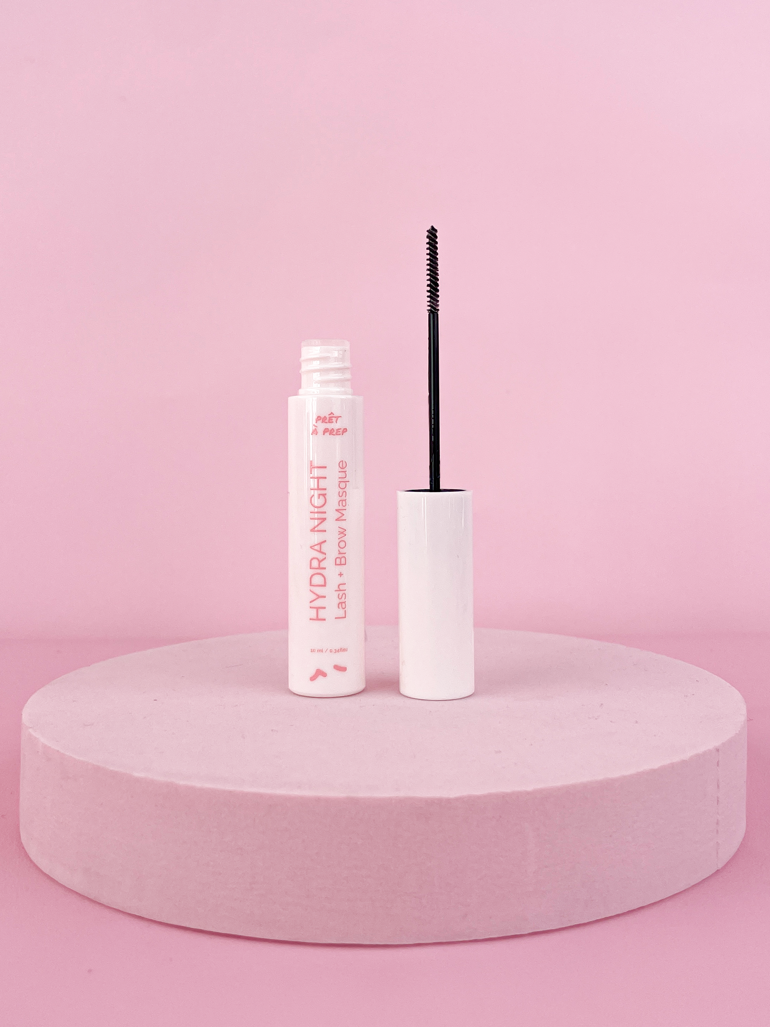 white slim mascara bottle on pink background